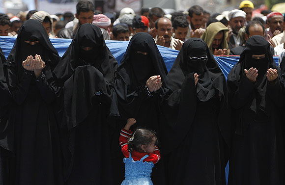 Women pray during a rally in Sana.