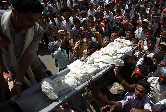 Mourners in Taizz carry the body of a boy who was slain last week during clashes between police and demonstrators.