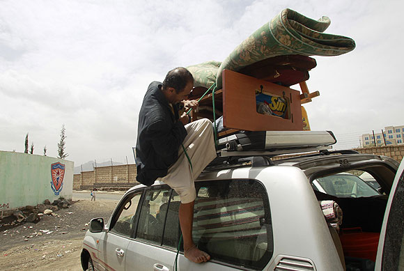 A man secures his possessions as he prepares to evacuate his family from Sana, Yemen