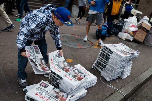 Passersby pick up the Occupied Wall Street Journal.