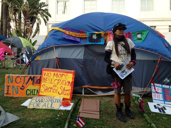 Regina Quetzal Quiñones outside one of the Indigenous Peoples’ Committee tents in downtown Los Angeles.