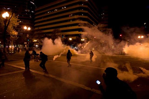 Police use tear gas to disperse Occupy Oakland protesters.