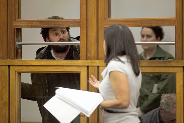 John Doe II, who was arrested during the Occupy L.A. raid, attempts to get a last word in with deputy public defender Carrie Miner as she defends him in Los Angeles' Central Arraignment Court. He was released with no charges.