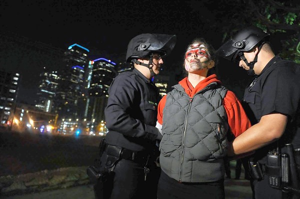 Los Angeles police officers arrest an Occupy L.A. protester near the City Hall encampment. (Nov. 30, 2011)