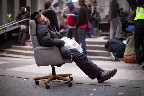 An Occupy Wall Street protester falls asleep in an armchair.