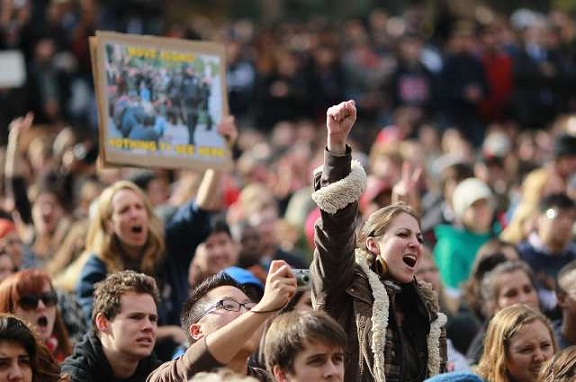 A student pumps her fist during a demonstration at UC Davis. (Nov. 21, 2011)