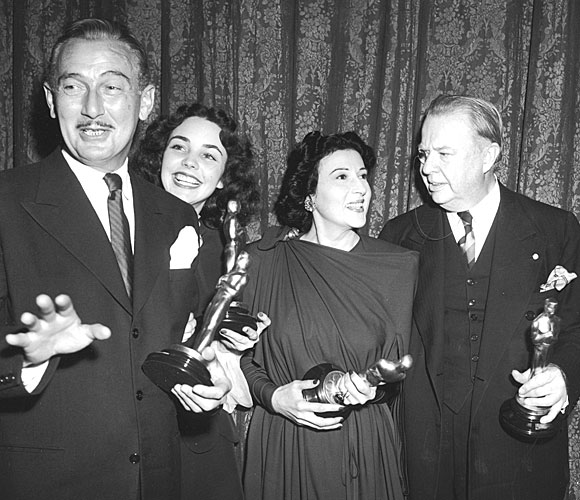 Paul Lukas, left, Jennifer Jones, Katina Paxinou and Charles Coburn pose backstage with their statuettes. 