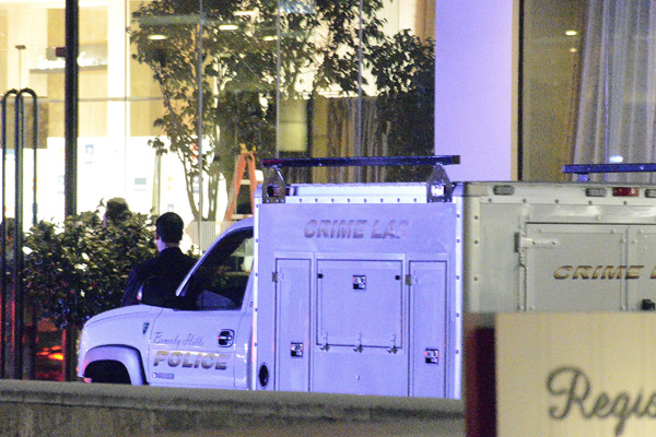 A Los Angeles police crime lab truck sits in the driveway of the Beverly Hilton Hotel.