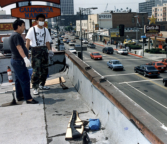 Employees of California Market in Koreatown guard the store from the rooftop. (May 1, 1992)