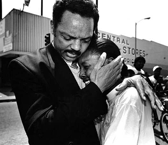 Jesse Jackson comforts Charlotte McKoy. (May 2, 1992)