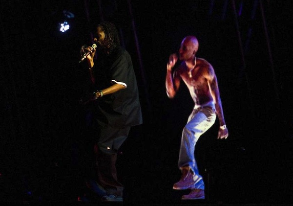 Snoop Dogg performs with an image of Tupac. 
