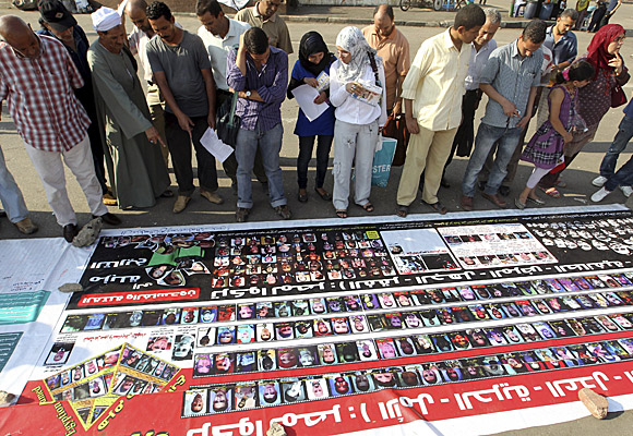 In Cairo's Tahrir Square, a banner is displayed with photos of some of the people killed during the uprising in Egypt. 