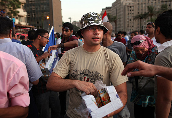 Ahmed Maher hands out juice to demonstrators in Cairo's Tahrir Square.