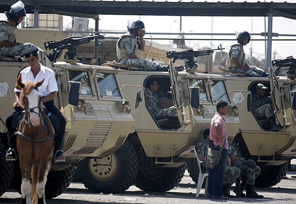 Soldiers stand guard at the court near Cairo where Hosni Mubarak and others are on trial.