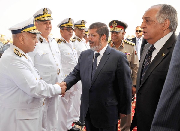 President-elect Mohamed Morsi, accompanied by Interior Minister Mohamed Ibrahim Youssef, right, meets with Egyptian police officers in Cairo. 