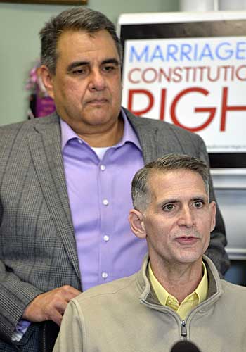 Greg Bourke, front, and his partner Michael Deleon speak to reporters following the announcement from U.S. District Judge John G. Heyburn.