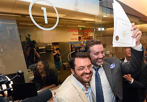 Antioco Carrillo, left, and Theo Small display their marriage license issued at the Clark County Marriage Bureau in Las Vegas, Nev.