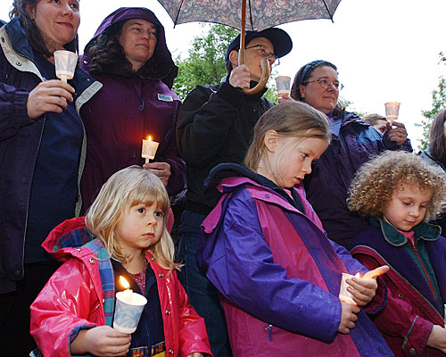 Couples Marcia and Jill Stanard, left and center left, and Lauren and Rivka Gevurts, center right and right, are joined by their children at a vigil in front of the Oregon Supreme Court in Salem on the eve of the decision on same-sex marriage.