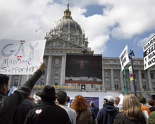 Supporters and foes of Proposition 8 watch a large-screen television outside San Francisco City Hall.