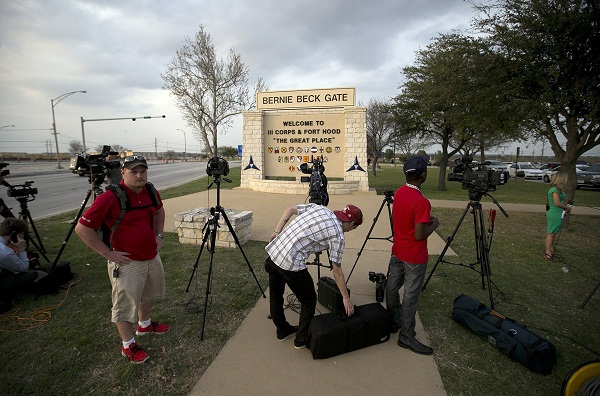 Media wait outside Fort Hood for an official statement Wednesday.