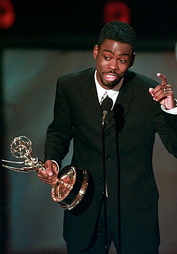 Chris Rock holds his Emmy for writing for a variety or music program for "Bring the Pain."
