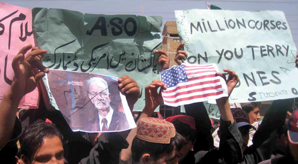 A protester holds a picture of US pastor Terry Jones, during a rally against "Innocence of Muslims" in Chaman, Pakistan.