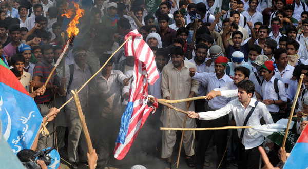 Pakistani activists burn a US flag during a protest against the anti-Islam movie in Lahore.