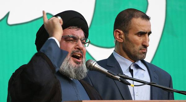 Hezbollah leader Sheik Hassan Nasrallah, left, speaks to a crowd of tens of thousands of supporters during a rally denouncing an anti-Islam film that has provoked a week of unrest in Muslim countries worldwide.