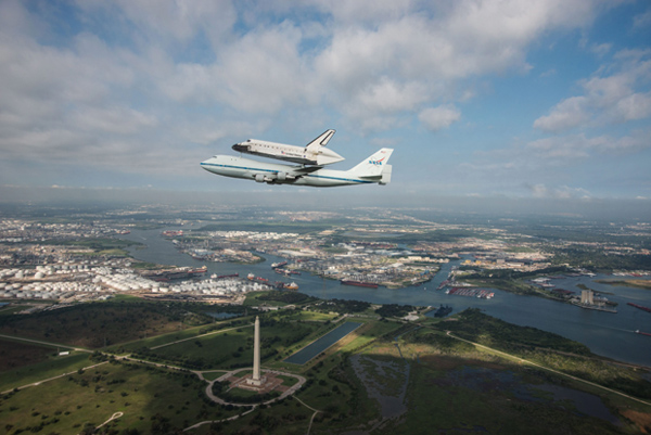 The space shuttle Endeavour is ferried over San Jacinto Monument in Houston on Wednesday.