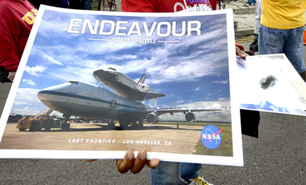 Man selling space shuttle Endeavour posters. 
