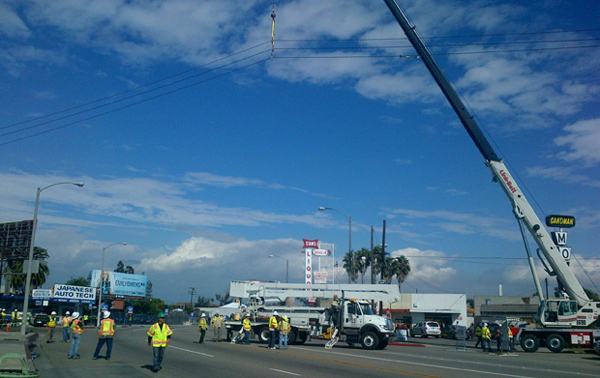 Southern California Edison employees lift electrical lines in Endeavour's path along Manchester Boulevard. 