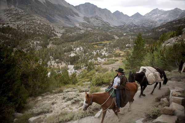 Mary Breckenridge crosses over Mono pass from the west side to the east side with her horse, Surprise, and mules, Dixie and Woody. 