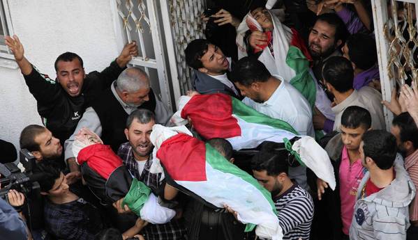 In Gaza City, Palestinians carry the bodies of members of the Dalu family killed in an Israeli airstrike.