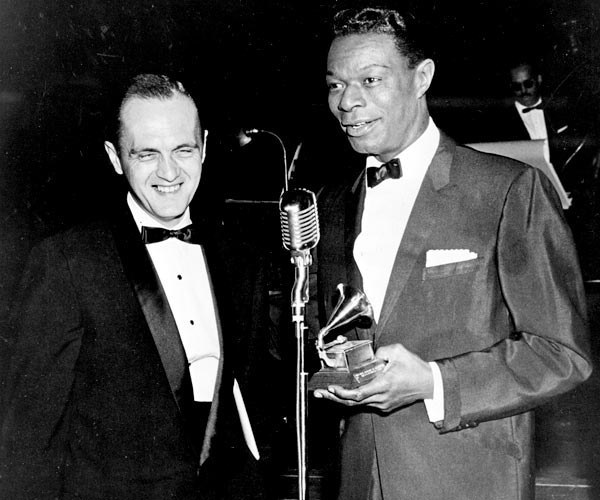 Bob Newhart, left, and Nat King Cole speak during the Grammy Awards ceremony in 1961.