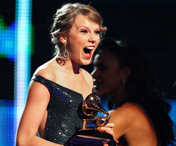 Taylor Swift reacts after winning four Grammys at the 52nd Grammy Awards in Los Angeles.