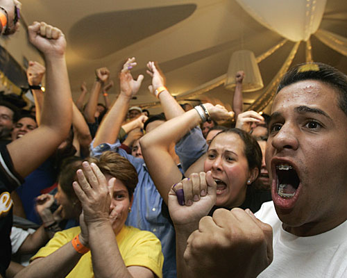 Members of Venezuela's opposition celebrate at their headquarters in the capital after hearing that President Hugo Chavez suffered a defeat in a vote on constitutional changes that would have let him run for reelection indefinitely.