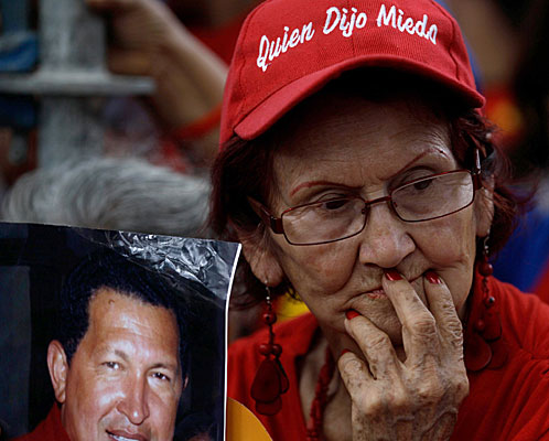 A woman holds an image of Venezuela's President Hugo Chavez during a demonstration in support of him at the Simon Bolivar square in Caracas, Venezuela.