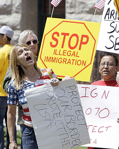 Supporters of immigration bill SB1070 shout as they rally at the Arizona Capitol prior to Arizona Gov. Jan Brewer signing the bill into law.