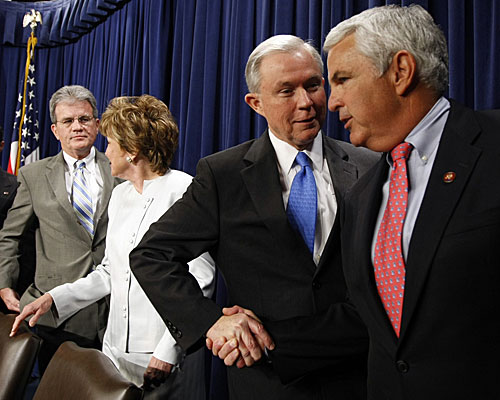 Sen. Jeff Sessions (R-Ala.), second from right, greets Rep. John Shadegg (R-Ariz.) at a news conference attended by other senators who opposed the legislation. 