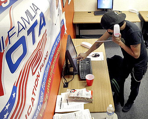 Pedro Yazzie makes phone calls in Phoenix to registered voters from the offices of Mi Familia Vota, a non-partisan effort to increase voter participation among Latinos and others.