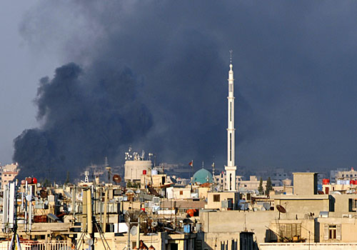 An amateur photo shows smoke rising over Damascus after Syrian rebels bombed the national security headquarters, killing the defense minister, his deputy and an assistant vice president.