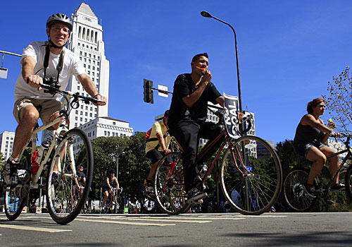 With a backdrop of City Hall, cyclists cruise along Spring Street during the car-free CicLAvia bicycle and pedestrian celebration in downtown Los Angeles.
