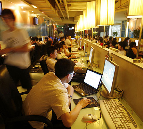 Customers use computers at an Internet cafe in Shanghai on Nov. 15, 2008.