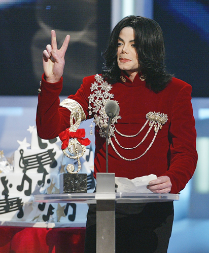 Michael Jackson makes a peace sign at the MTV Video Music Awards in 2002.