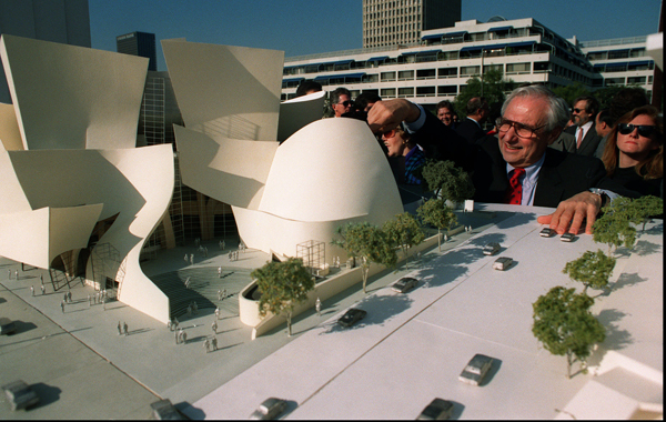 Architect Frank Gehry looks over a model of Walt Disney Concert Hall during groundbreaking ceremonies in Los Angeles.