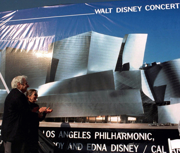 Architect Frank Gehry, left, and Diane Disney Miller, daughter of Walt Disney, applaud as a giant mural of Walt Disney Concert Hall is unveiled during a construction commencement ceremony. 