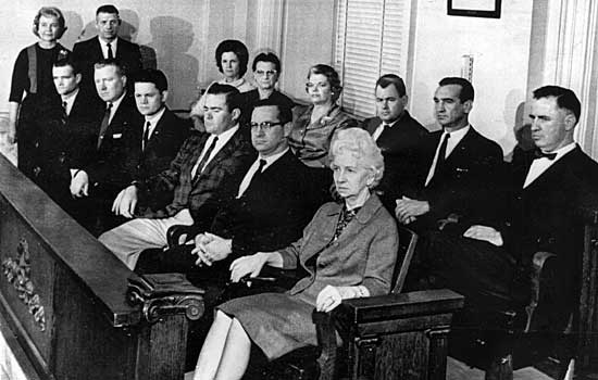 Seated in the second row are Mildred McCollum, Aileen B. Shields, Gwen L. English, Douglas J. Sowell, J. Waymon Rose and Allen W. McCoy. Seated in the front row are Luther Gene Dickerson, Max E. Causey, R.J. Flechtner Jr., J.G. Holton, James E. Cunningham and Louise Malone. Standing at left rear are bailiffs Nell Tyler and W.W. Mabra.