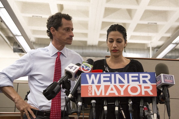 Anthony Weiner apologizes to the public alongside his wife, Huma Abedin.