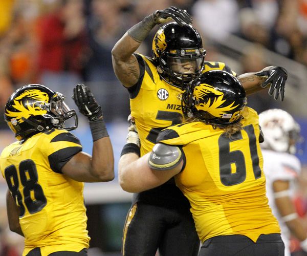 Missouri running back Henry Josey celebrates with teammates after scoring the go-ahead touchdown in the fourth quarter against Oklahoma State in the Cotton Bowl. Josey finished with 92 yards rushing and three touchdowns in the victory.