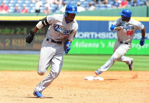Dodgers teammates Dee Gordon, left, and Yasiel Puig run the bases during ninth inning of the team's 6-4 win over the Atlanta Braves.